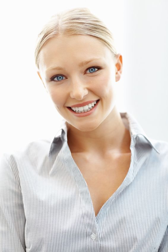 A blonde woman smiling with porcelain crowns in Alexandria.