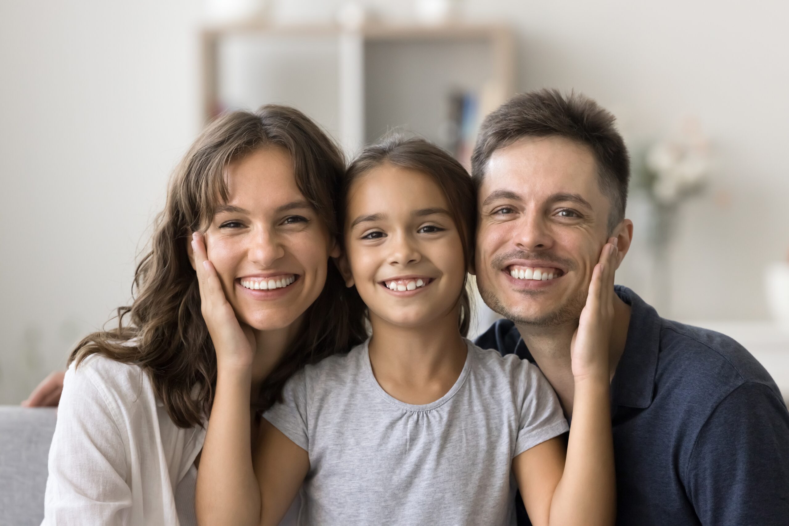 smiling family, little girl in between mom and dad
