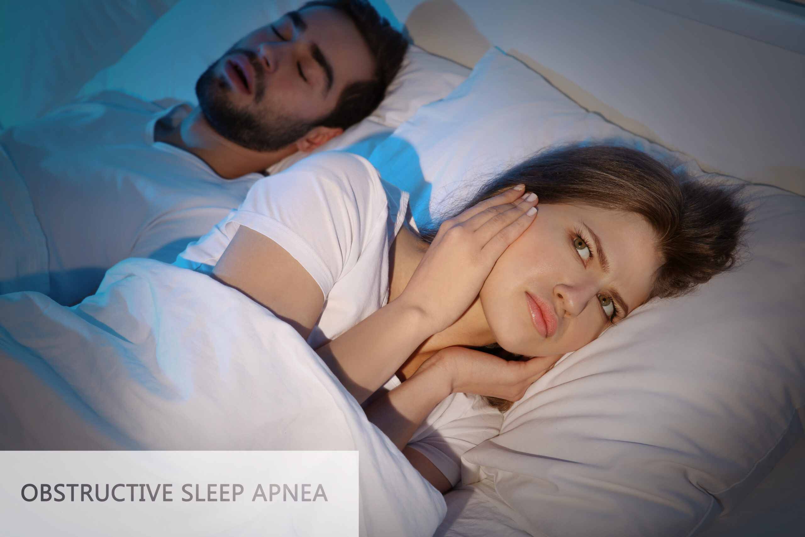man suffering from sleep apnea and disturbing his partner