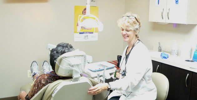 A patient during an implant-supported dentures consultation in Alexandria.