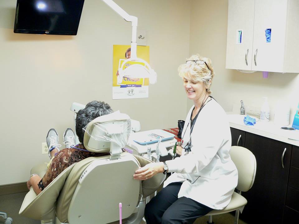 A patient during an implant-supported dentures consultation in Alexandria.